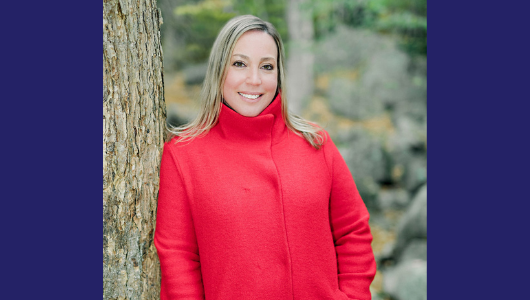 Caitlin Roberts smiling while outside in nature.