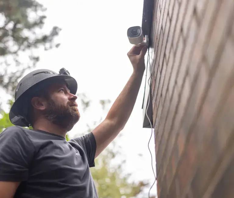 Eastlink Technician installing equipment outside a home